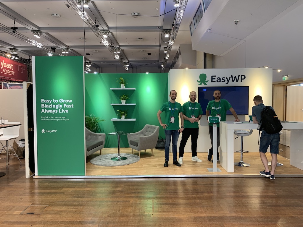 Three members of the EasyWP team at a booth. 