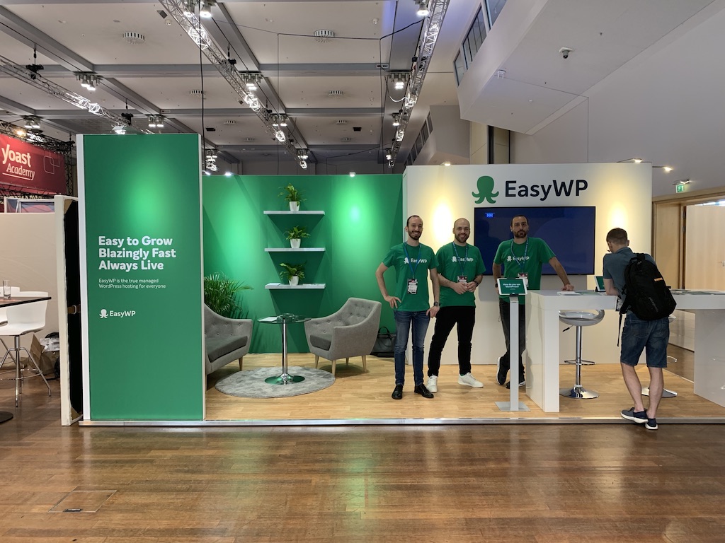 Three members of the EasyWP team at a booth.