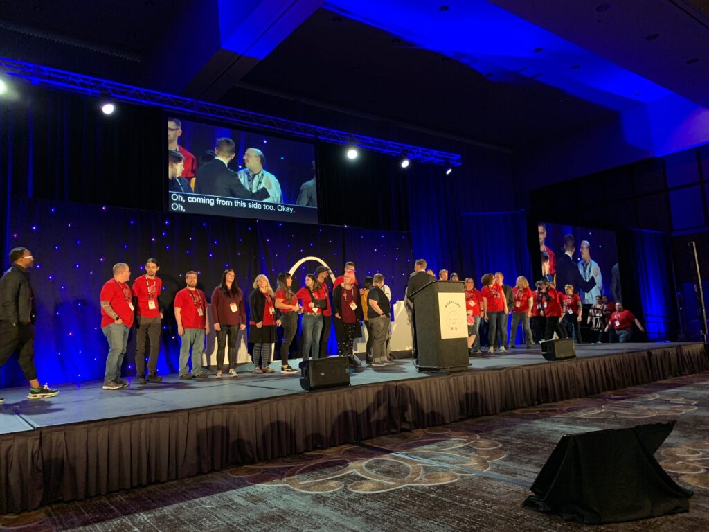 Matt Mullenweg invites WordCamp US volunteers up onto the stage to show thanks. 