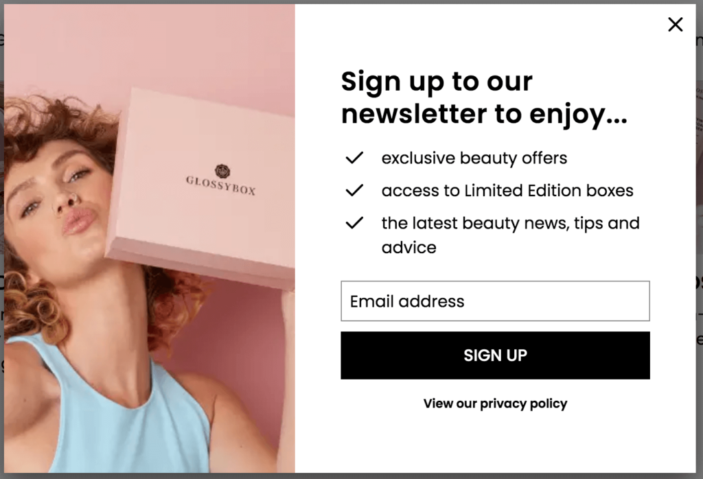 A newsletter form popup with a woman holding a pink box. 