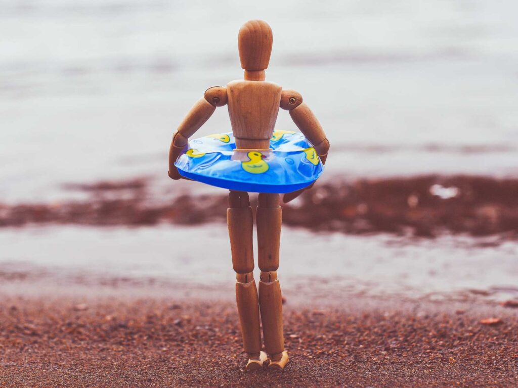 A wooden doll on the beach