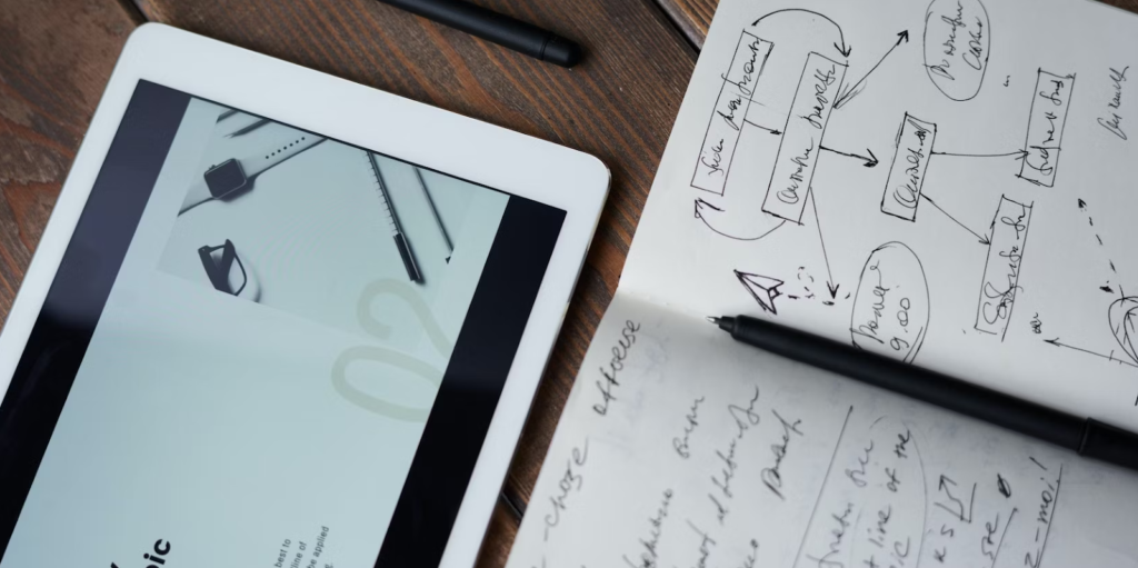 A notebook and iPad on a desk