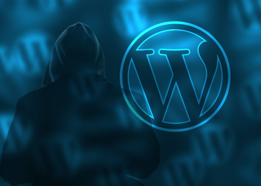 A hacker stands next to the WordPress logo