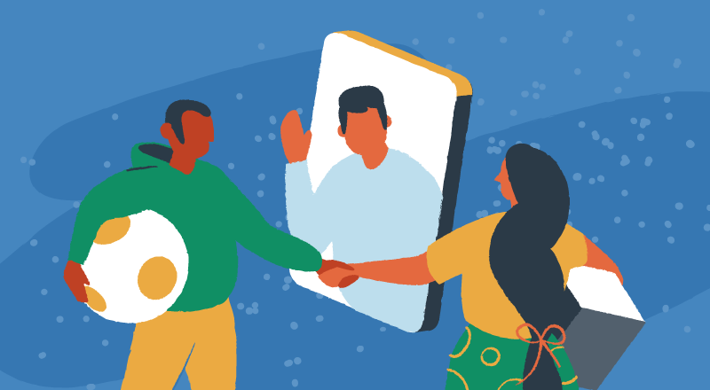 Two people hold hands in front of a person on a video call.
