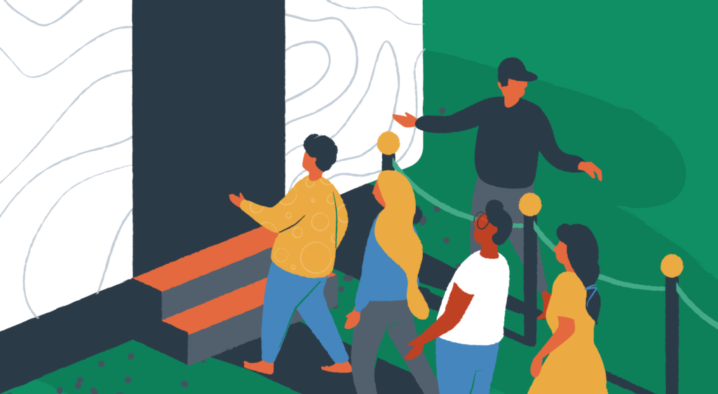 A security guard works to let people through a door in an organized way.